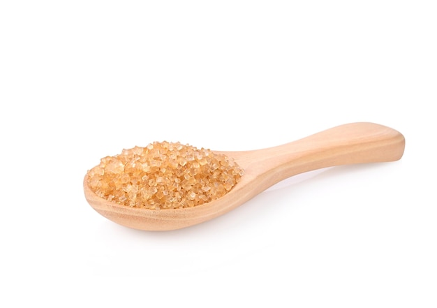 Brown cane sugar in wooden spoon on white background