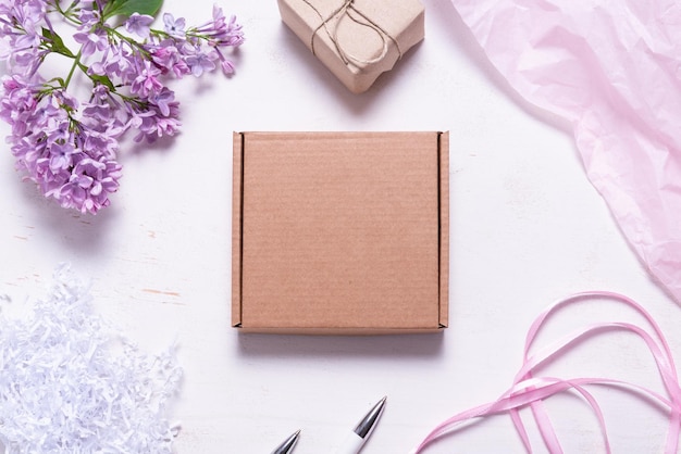 Brown cardboard box decorated with lilac branch