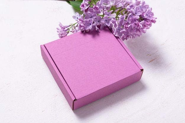 Brown cardboard box decorated with lilac branch