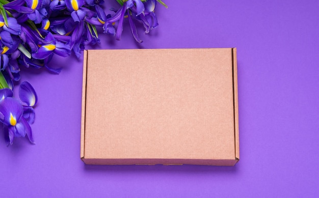 Brown carton cardboard box embellished with fresh iris flowers