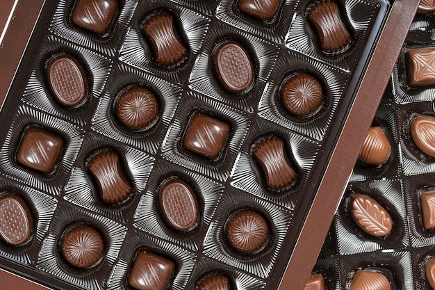 Brown chocolate candy background Assortment of chocolate candies sweets in the box