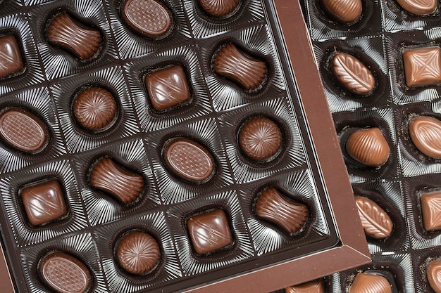 Brown chocolate candy background Assortment of chocolate candies sweets in the box