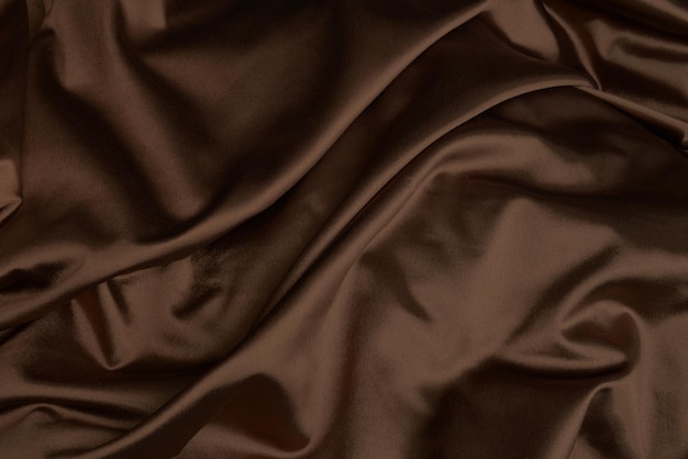 Brown or chocolate silk satin fabric texture for background luxury silk cloth