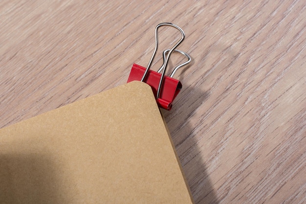 Brown color open notebook and a paper clip