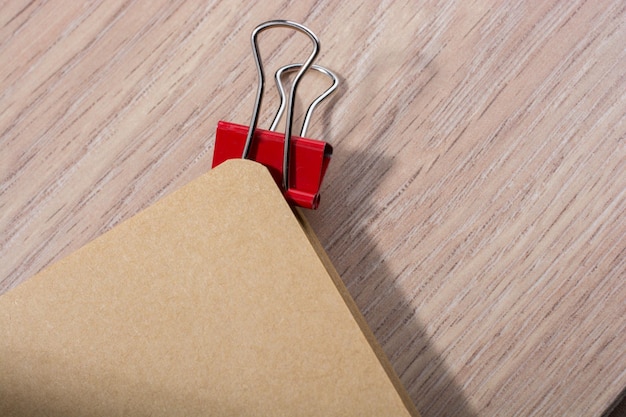 Brown color open notebook and a paper clip