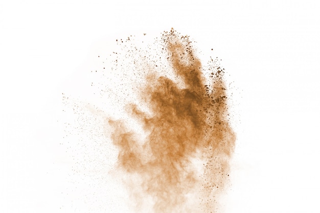 Brown color powder explosion on white background. Colored cloud. Colorful dust explode. 