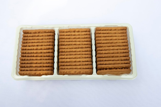 Brown color Wheat biscuits in the Plastic tray isolated on Background