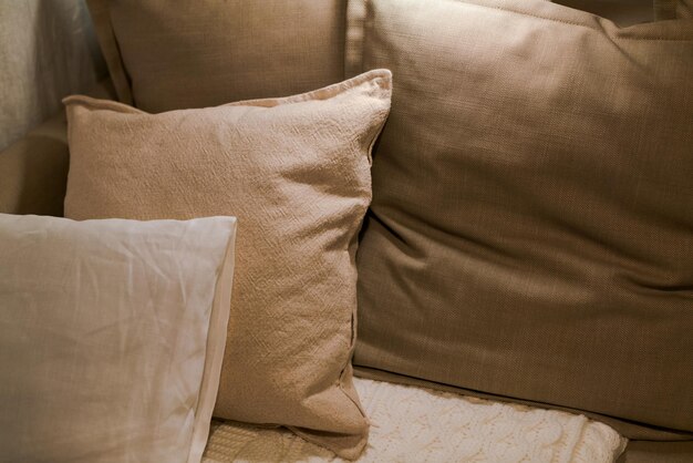 Photo a brown couch with a pillow that says " the word " on it.