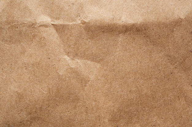 Brown crumpled paper recycled kraft sheet texture background