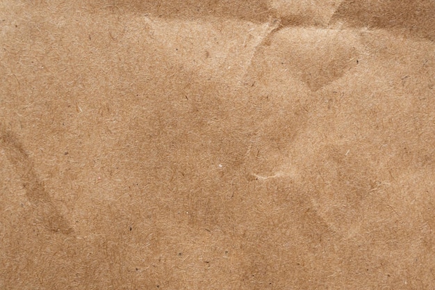 Brown crumpled paper recycled kraft sheet texture background