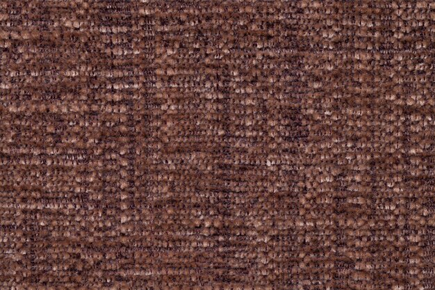 Brown fluffy background of soft, fleecy cloth. Texture of textile closeup