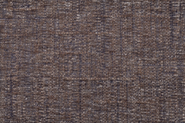 Brown fluffy background of soft, fleecy cloth. Texture of textile closeup