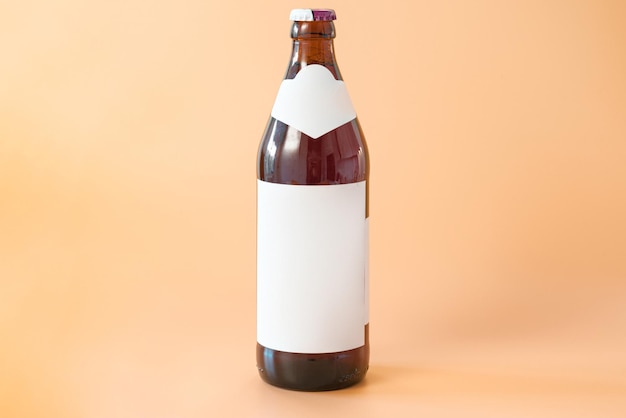 A brown glass bottle of beer with two white blank labels on an yellow background Cool Golden Drunk Fluid Gold Brewed Alcoholic Refreshing Pub Chill Brand Product Bottle