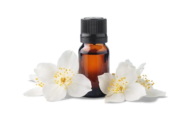 Brown glass bottle with essential oil and jasmine flowers isolated on white background. Essence liquid for skin care or alternative medicine.