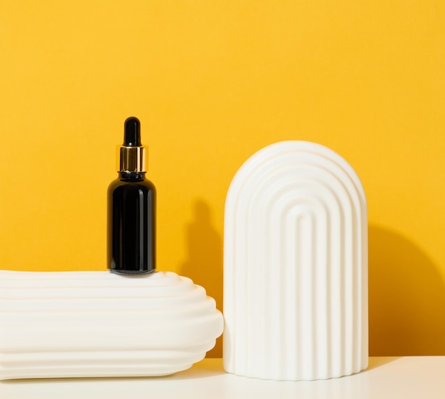 Brown glass bottle with pipette stands on a white table. Cosmetics SPA branding. Packaging for gel, serum, advertising and product promotion, mock up