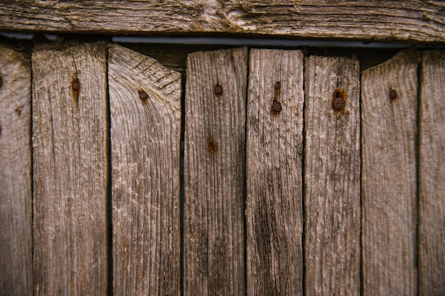 Brown or gray wood texture. Abstract background. rustic background of old wooden boards with holes and nails.