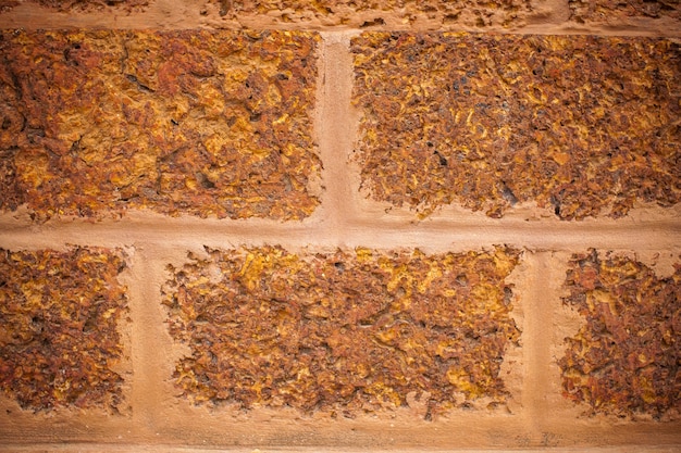 Brown laterite stone wall.