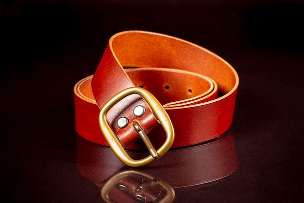 Brown leather belt on a dark background