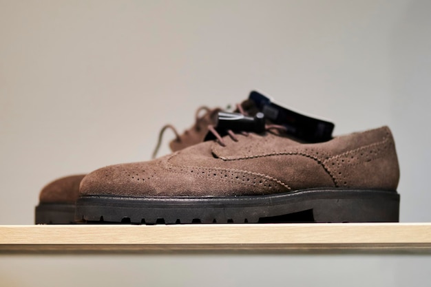 brown leather matte men's shoes on a shelf in a shoe store, close-up