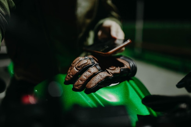 brown leather motorcycle gloves on the tank of a motorcycle