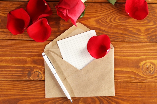 Brown notebook with white pen on a wooden table background Valentine's day february 14