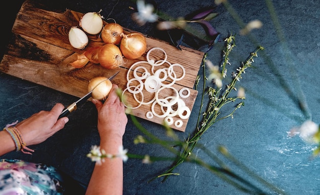 Brown onions and slices on wooden cutting board.Healthy food background.