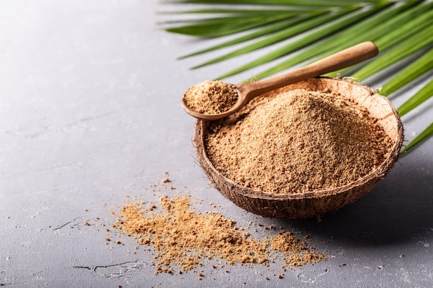 Brown palm sugar in a coconut shell