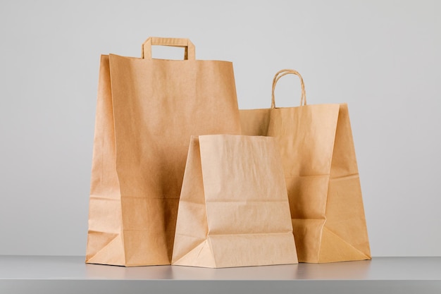 Brown paper bag with handles, empty shopping bag with area for your logo or design, food delivery concept.