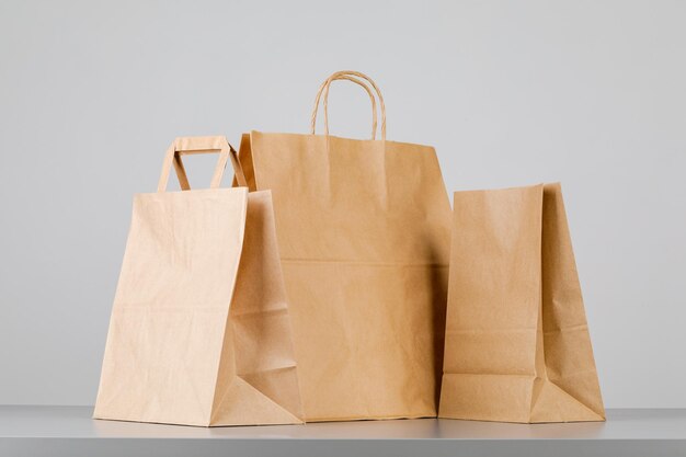 Brown paper bag with handles, empty shopping bag with area for your logo or design, food delivery concept.