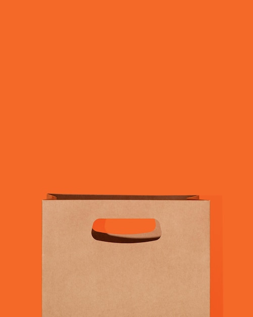 Brown paper package on orange background Mockup