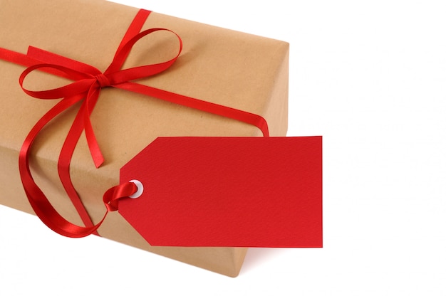 Brown paper package tied with red ribbon and gift tag.