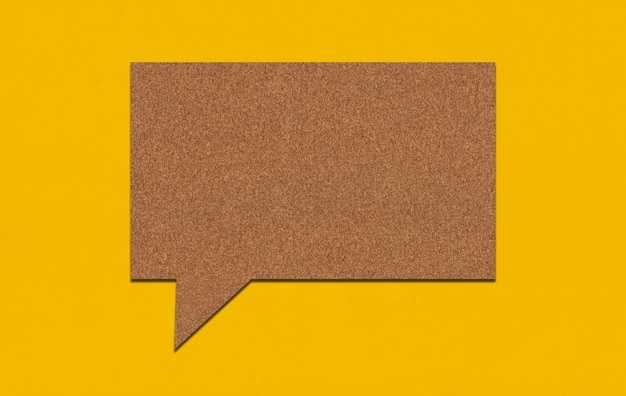 Brown paper speech bubble on yellow paper background