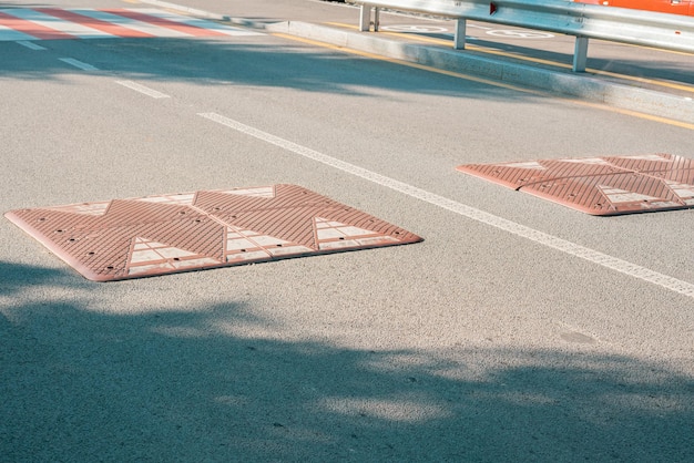 Brown rectangular speed bumps installed on the road Nobody Roadblock Control Direction Slow Way Device Motion Police Officer Sleeping Sign Policeman Caution Crossing