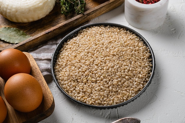 Brown rice with ingredients, on white stone table background, on white stone table background