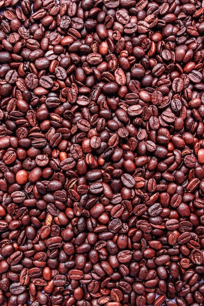 Brown roasted coffee beans background. Arabic fragrant fried coffee beans, close up.