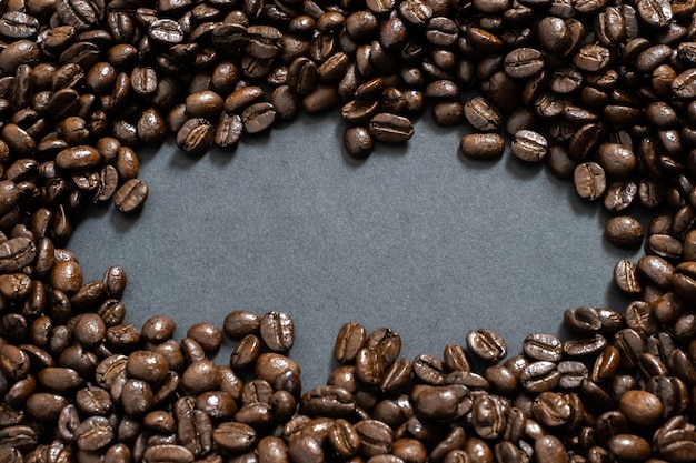 Brown roasted coffee beans, seed on dark background 