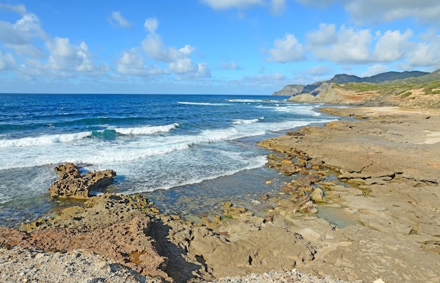 Brown rocks and rough sea in Argentiera Sardinia