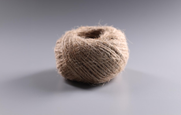 Brown rope roll skein of jute twine on grey background