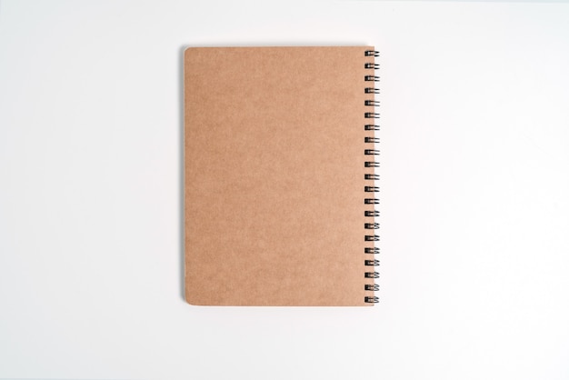 Brown spiral notebook isolated on white background.top view