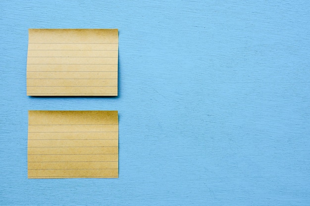 Brown sticky notes isolated on blue