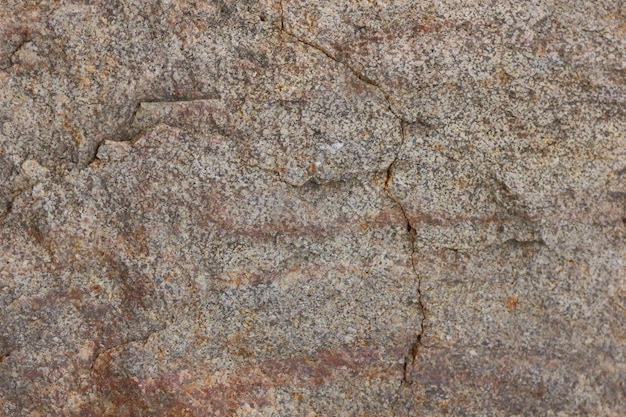 Brown stone or rock background Rough brown stone wall Closeup view of textured weathered surface