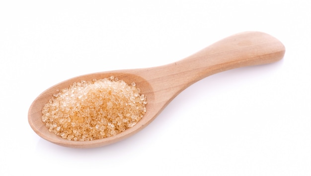 Brown sugar in wooden spoon isolated