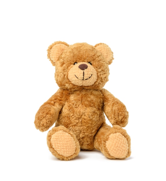 Brown teddy bear sits on a white surface, toy