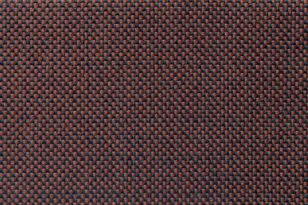 Brown textile background with checkered pattern, closeup. 