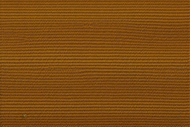 A brown textured fabric with a yellow pattern.