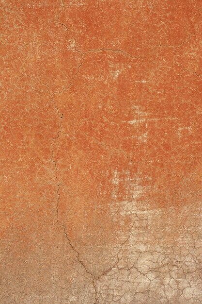 A brown wall with a crack in it that says'rust '