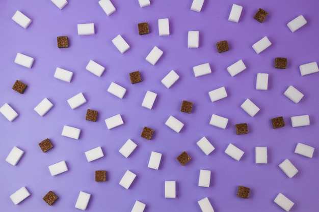 Brown and white sugar cubes pattern on violet background