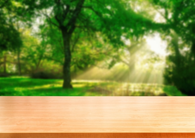 Brown wood table in green blur nature background.