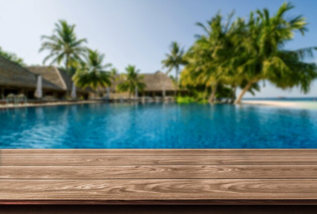 Brown wood table in summer seaside resort with empty copy space on table for product display mockup.