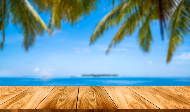 Brown wood table on summer tropical beach.